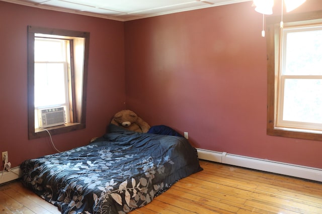 63 Province St, Richford, VT 05476 - bedroom with a baseboard heating unit, wood-type flooring, baseboard heating, and ornamental molding