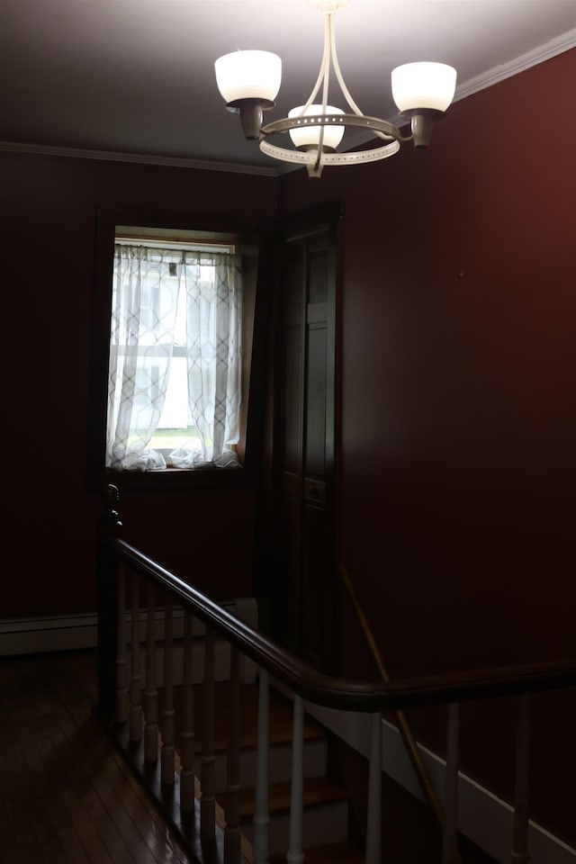 63 Province St, Richford, VT 05476 - stairway featuring a baseboard heating unit, crown molding, and wood-type flooring