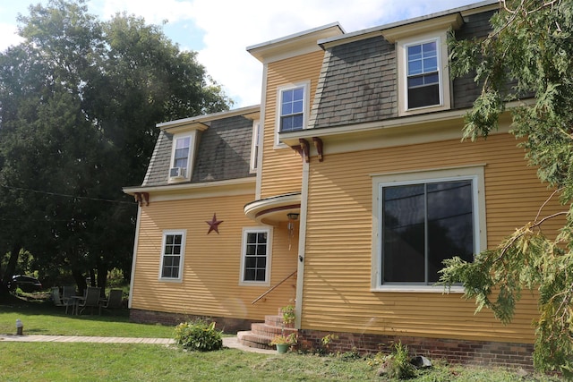 63 Province St, Richford, VT 05476 - rear view of house with entry steps, mansard roof, a lawn, and roof with shingles