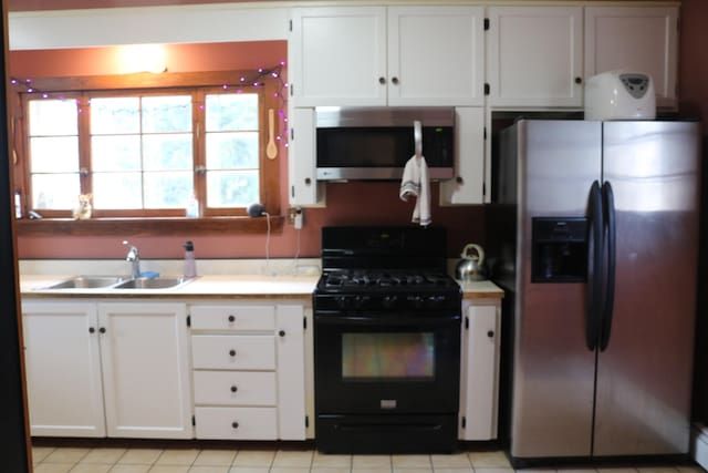 63 Province St, Richford, VT 05476 - kitchen featuring a sink, light countertops, white cabinetry, and stainless steel appliances