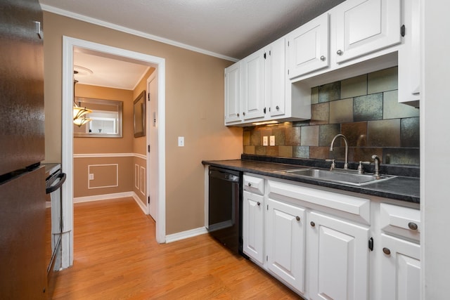 kitchen with ornamental molding, a sink, black appliances, white cabinets, and light wood-type flooring