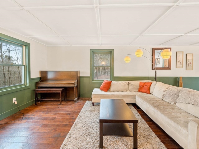 living area with a wainscoted wall and dark wood-style flooring