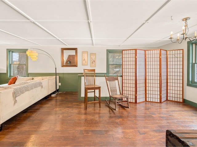 living area with an inviting chandelier and wood finished floors
