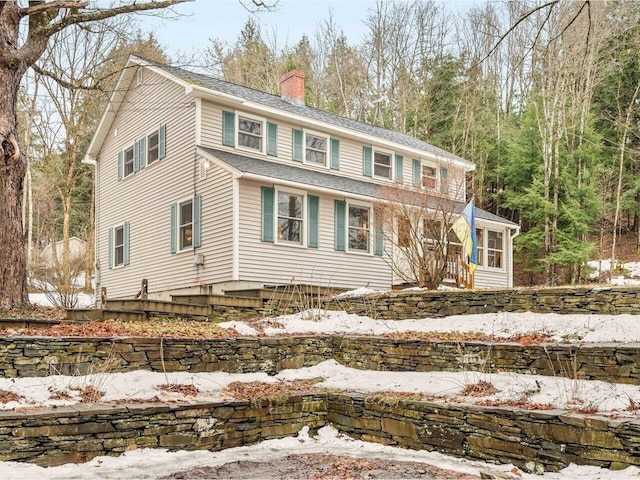 view of front of home featuring a chimney