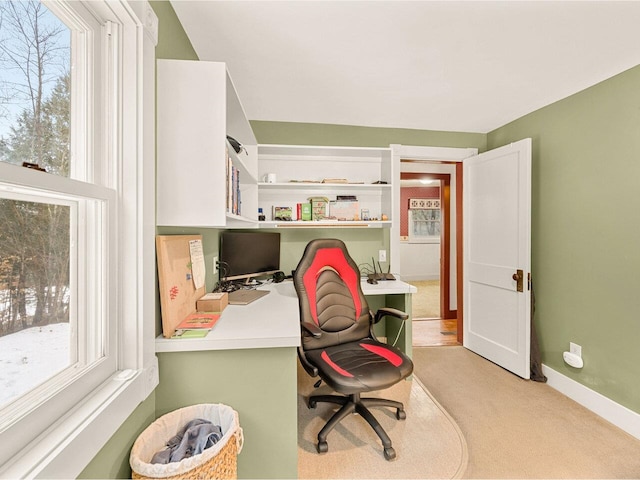 home office with a healthy amount of sunlight, light colored carpet, and baseboards