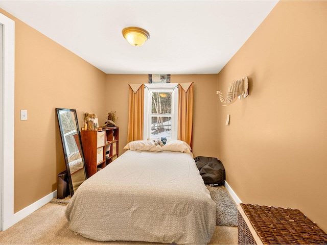 carpeted bedroom featuring baseboards