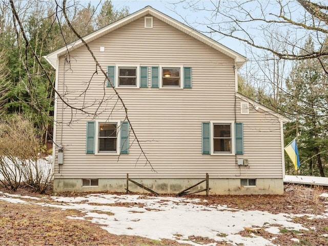 view of side of property with crawl space