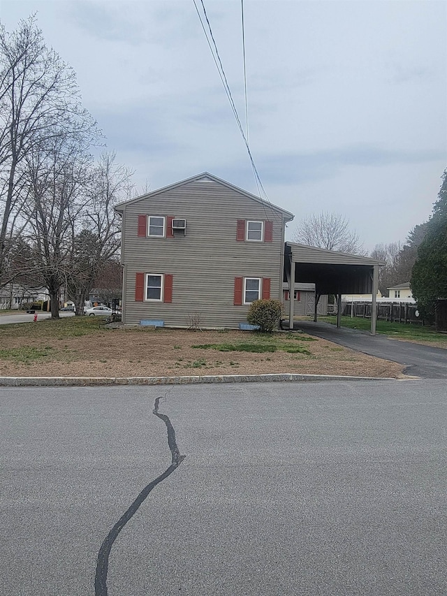 view of front facade with aphalt driveway and an attached carport