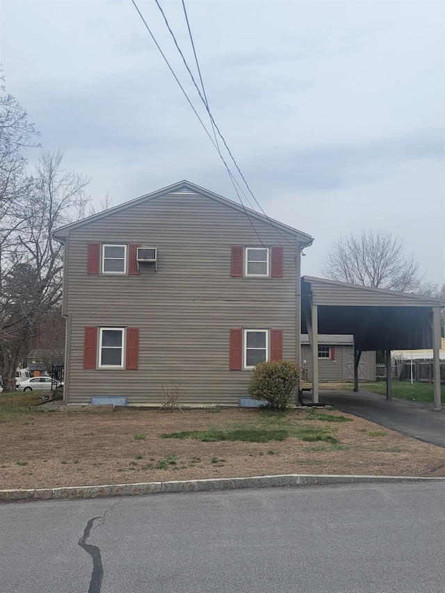 view of property exterior featuring aphalt driveway and an attached carport