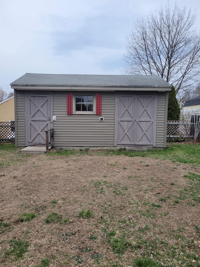 view of shed with fence