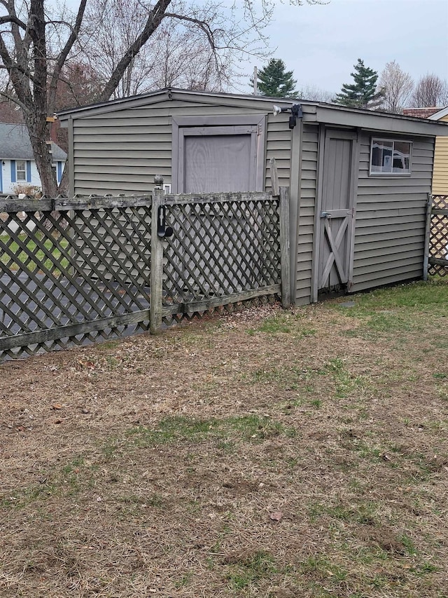 view of shed featuring fence