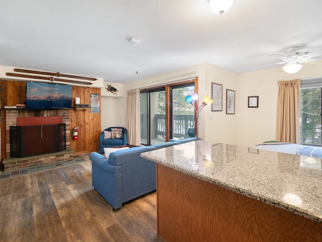 133 E Mountain Rd Unit 3C17, Killington, VT 05751 - living area featuring a fireplace, ceiling fan, and wood finished floors
