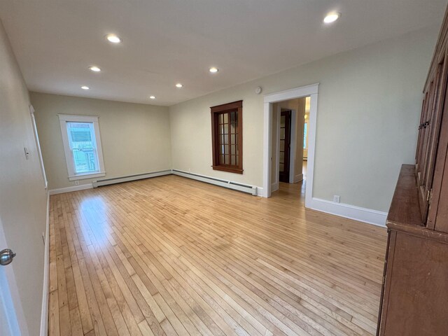42 Elm St, Claremont, NH 03743 - spare room with light wood-style floors, recessed lighting, a baseboard heating unit, baseboards, and baseboard heating