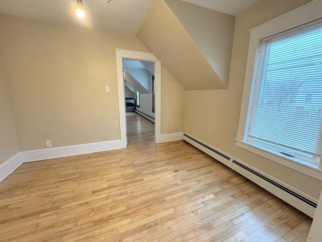 42 Elm St, Claremont, NH 03743 - additional living space featuring a baseboard radiator, light wood-style floors, lofted ceiling, and baseboards