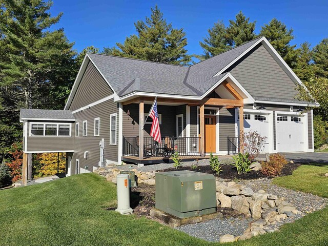7 John Hardie Way, Chichester, NH 03234 - view of front of house with a shingled roof, a porch, a garage, and a front lawn