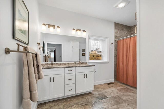 7 John Hardie Way, Chichester, NH 03234 - full bathroom with double vanity, baseboards, curtained shower, and a sink