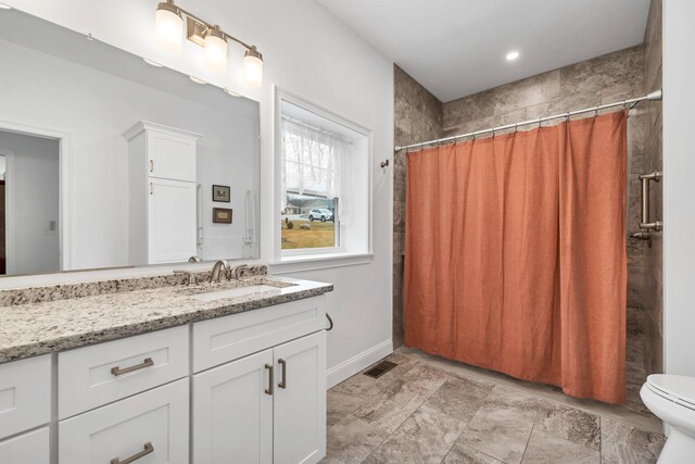 7 John Hardie Way, Chichester, NH 03234 - full bathroom featuring a shower with curtain, vanity, toilet, baseboards, and visible vents