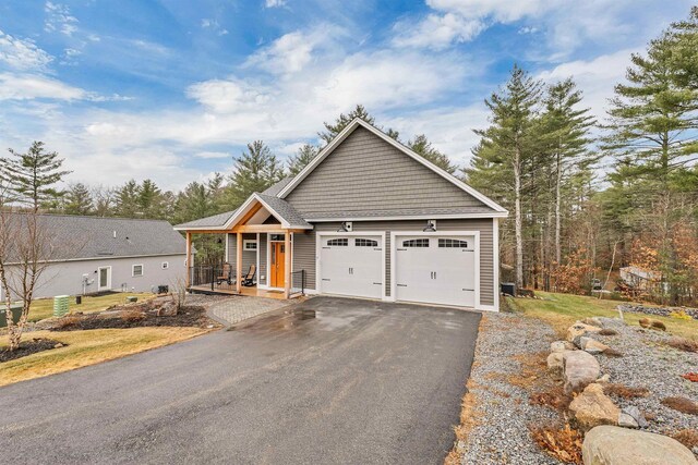 7 John Hardie Way, Chichester, NH 03234 - view of front of home featuring covered porch, an attached garage, and aphalt driveway