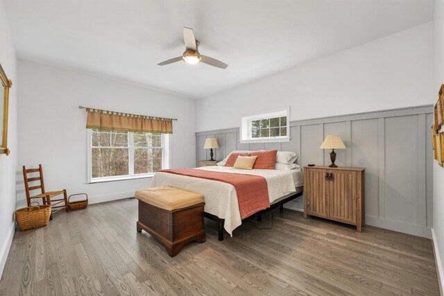 7 John Hardie Way, Chichester, NH 03234 - bedroom with multiple windows, wainscoting, wood finished floors, and a ceiling fan