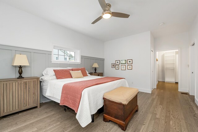 7 John Hardie Way, Chichester, NH 03234 - bedroom featuring a wainscoted wall, ceiling fan, and light wood-type flooring