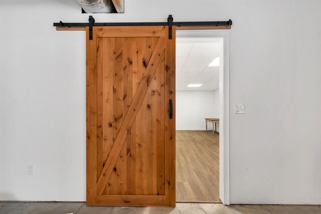 7 John Hardie Way, Chichester, NH 03234 - interior space featuring baseboards, a barn door, wood finished floors, and a drop ceiling