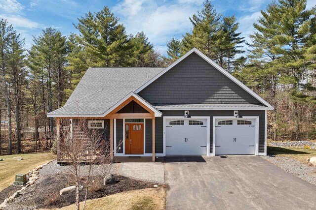 7 John Hardie Way, Chichester, NH 03234 - view of front facade with driveway, a shingled roof, and a garage