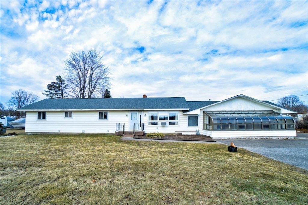 411 Rte 7, Milton, VT 05468 - ranch-style home with a sunroom and a front lawn