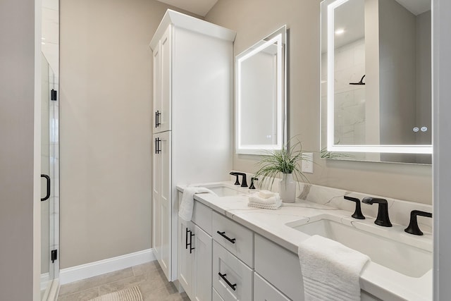full bathroom with a stall shower, tile patterned floors, and a sink