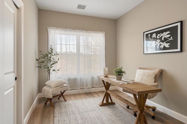 office featuring wood finished floors, baseboards, and visible vents