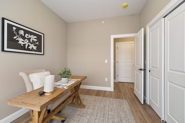office space with baseboards and wood finished floors
