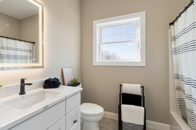 bathroom featuring baseboards, toilet, tile patterned floors, and vanity