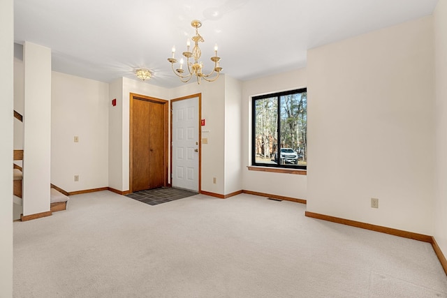 entrance foyer featuring an inviting chandelier, carpet floors, baseboards, and stairs