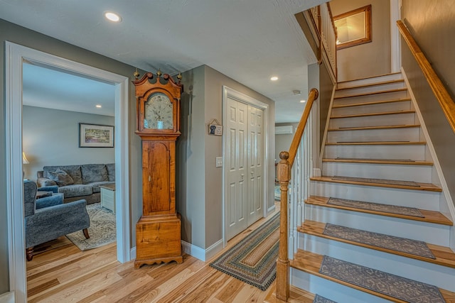 stairs featuring recessed lighting, baseboards, and wood finished floors