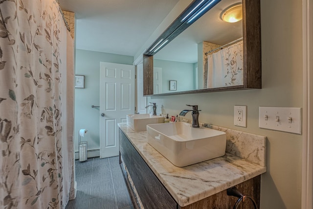 full bathroom featuring double vanity and a sink