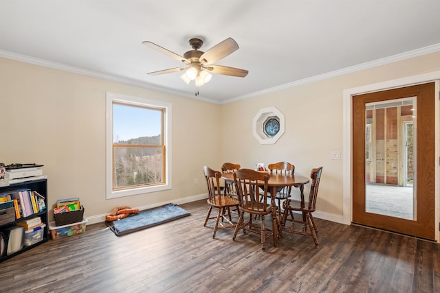 dining area featuring dark wood-type flooring, ceiling fan, baseboards, and ornamental molding