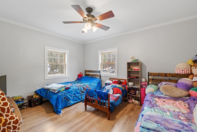bedroom featuring multiple windows, crown molding, and wood finished floors