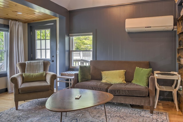 59 Wilson Pond Rd, Swanzey, NH 03431 - living room with an AC wall unit and light wood-type flooring