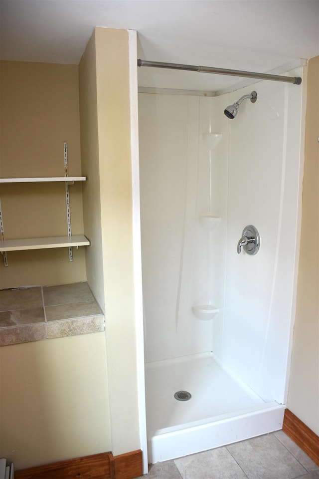 bathroom featuring a shower and tile patterned flooring
