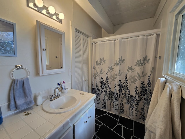 bathroom featuring curtained shower and vanity