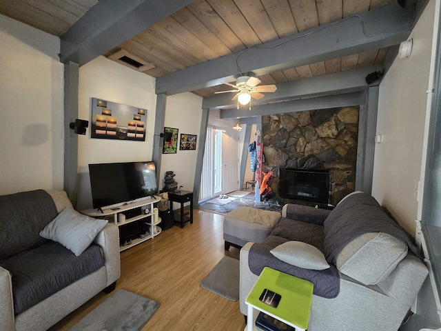 living area featuring light wood finished floors, beam ceiling, visible vents, a ceiling fan, and wood ceiling