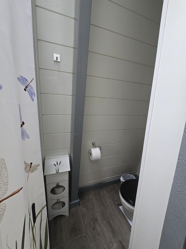 bathroom with wood finished floors and toilet