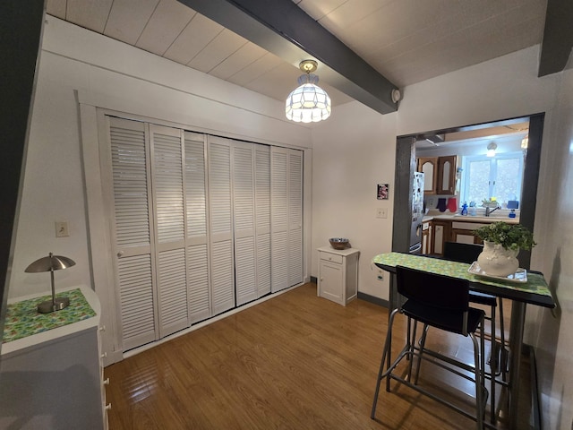 interior space with beamed ceiling and wood finished floors