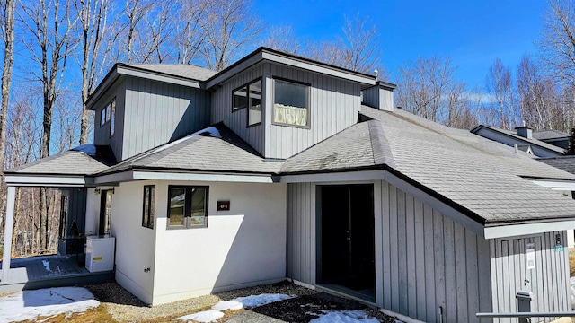 view of property exterior with a shingled roof
