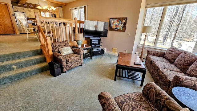 living area featuring stairs, an inviting chandelier, baseboards, a baseboard radiator, and light carpet