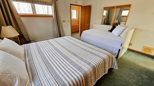 bedroom featuring multiple windows and carpet floors