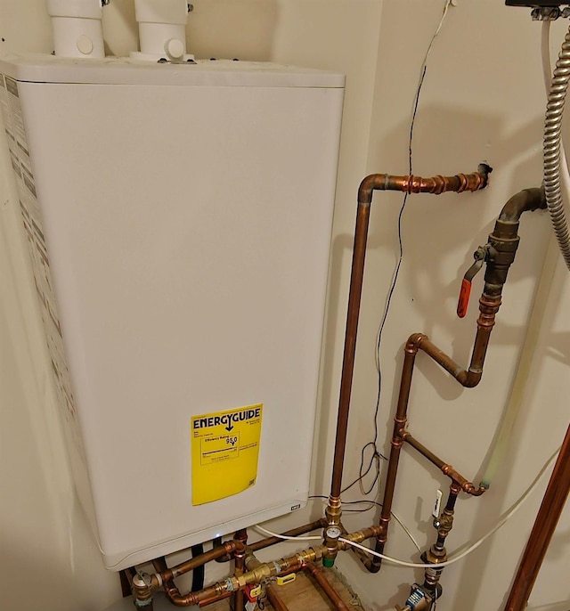 utility room featuring water heater