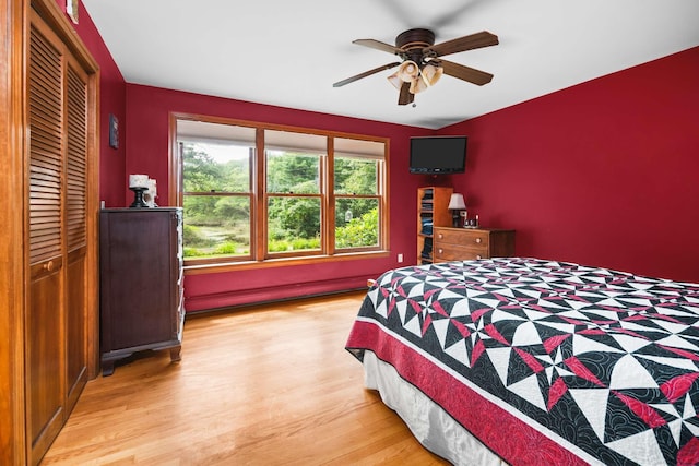 13 Ocean Circuit Dr, York, ME 03902 - bedroom featuring a baseboard radiator, a ceiling fan, a closet, and light wood finished floors