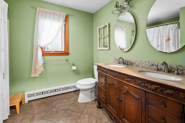 13 Ocean Circuit Dr, York, ME 03902 - bathroom with double vanity, a sink, toilet, and a baseboard radiator