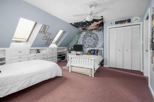 13 Ocean Circuit Dr, York, ME 03902 - carpeted bedroom featuring a closet, baseboards, lofted ceiling with skylight, and a ceiling fan
