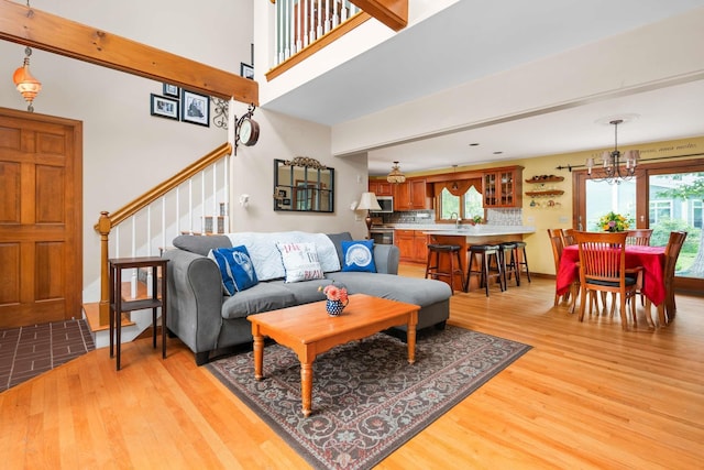 13 Ocean Circuit Dr, York, ME 03902 - living room with an inviting chandelier, light wood-style flooring, and stairs